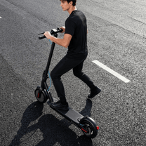 Mann auf dem SEEDREAM RED WING MINI E-Scooter auf der Straße