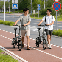 Zwei Fahrer mit dem YANGOR H19 faltbaren E-Bike in Beige auf einem Fußweg